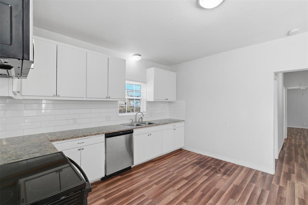 900 West Morgan Street Denison, TX 75020 - Photo 25 of 40 a kitchen with a sink window and cabinets