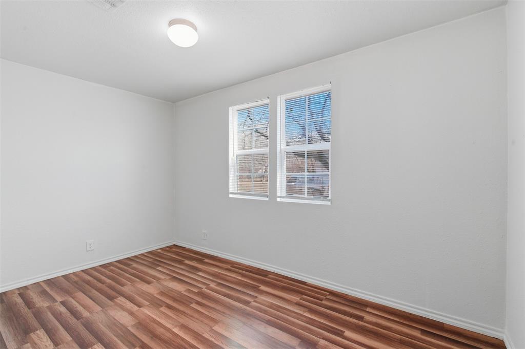 900 West Morgan Street Denison, TX 75020 - Photo 32 of 40 a view of a room with wooden floor and windows