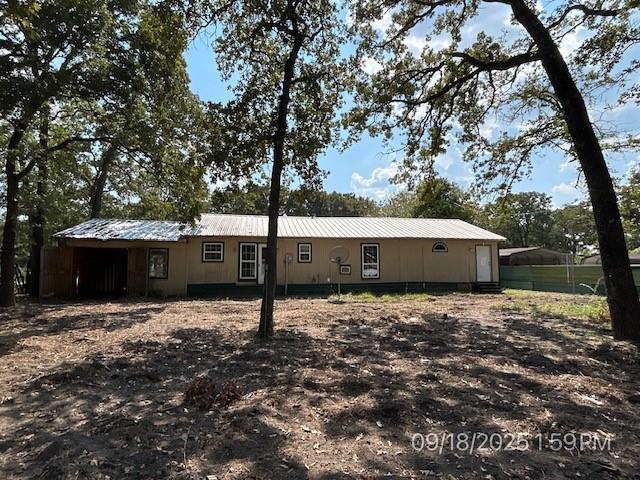 9672 Lakeland Loop Quinlan, TX 75474 - Photo 2 of 12 a backyard of a house with large trees and parked