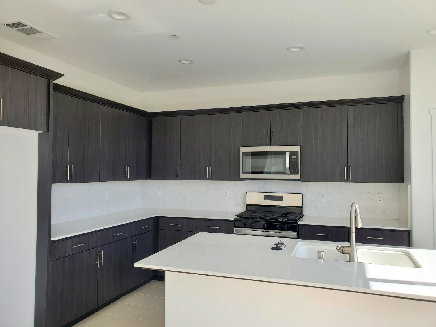 496 Talus Way South Madera, CA 93636 - Photo 4 of 9 a kitchen with sink and refrigerator