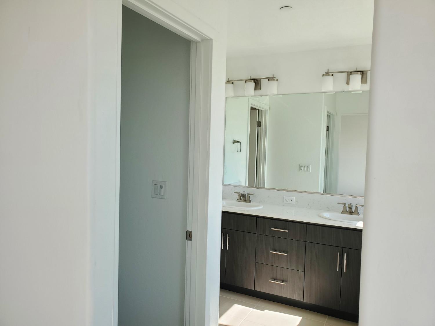 496 Talus Way South Madera, CA 93636 - Photo 8 of 9 a bathroom with a sink and a mirror