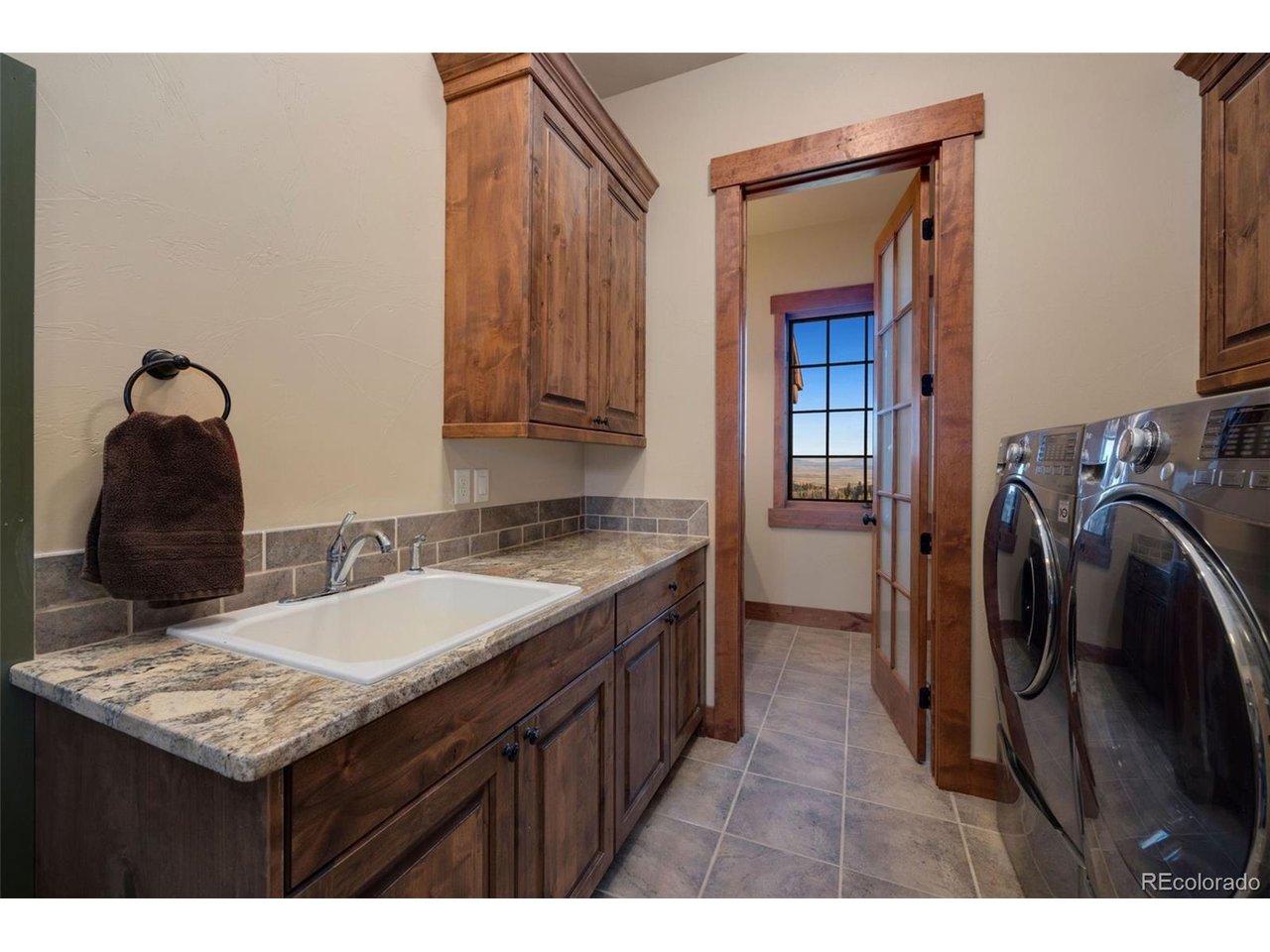 5200 Jackson Road Walden, CO 80480 - Photo 20 of 40 Main floor mud room with sink, washer/dryer additionally adjoining bathroom with sink and shower