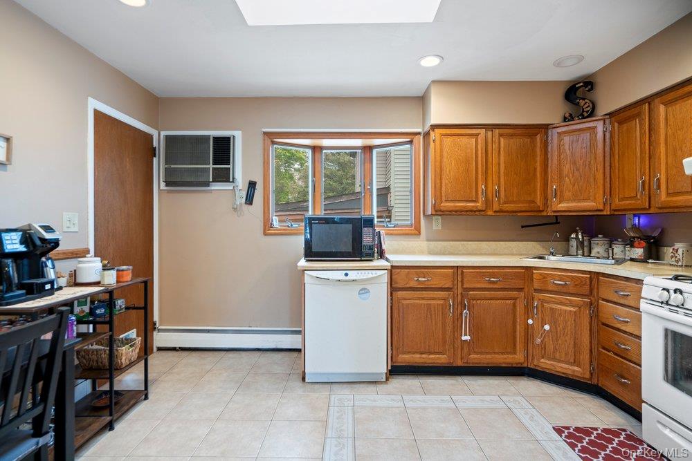 101 Sexton Road West Babylon, NY 11704 - Photo 17 of 33 a kitchen with stainless steel appliances granite countertop a stove a sink and a refrigerator