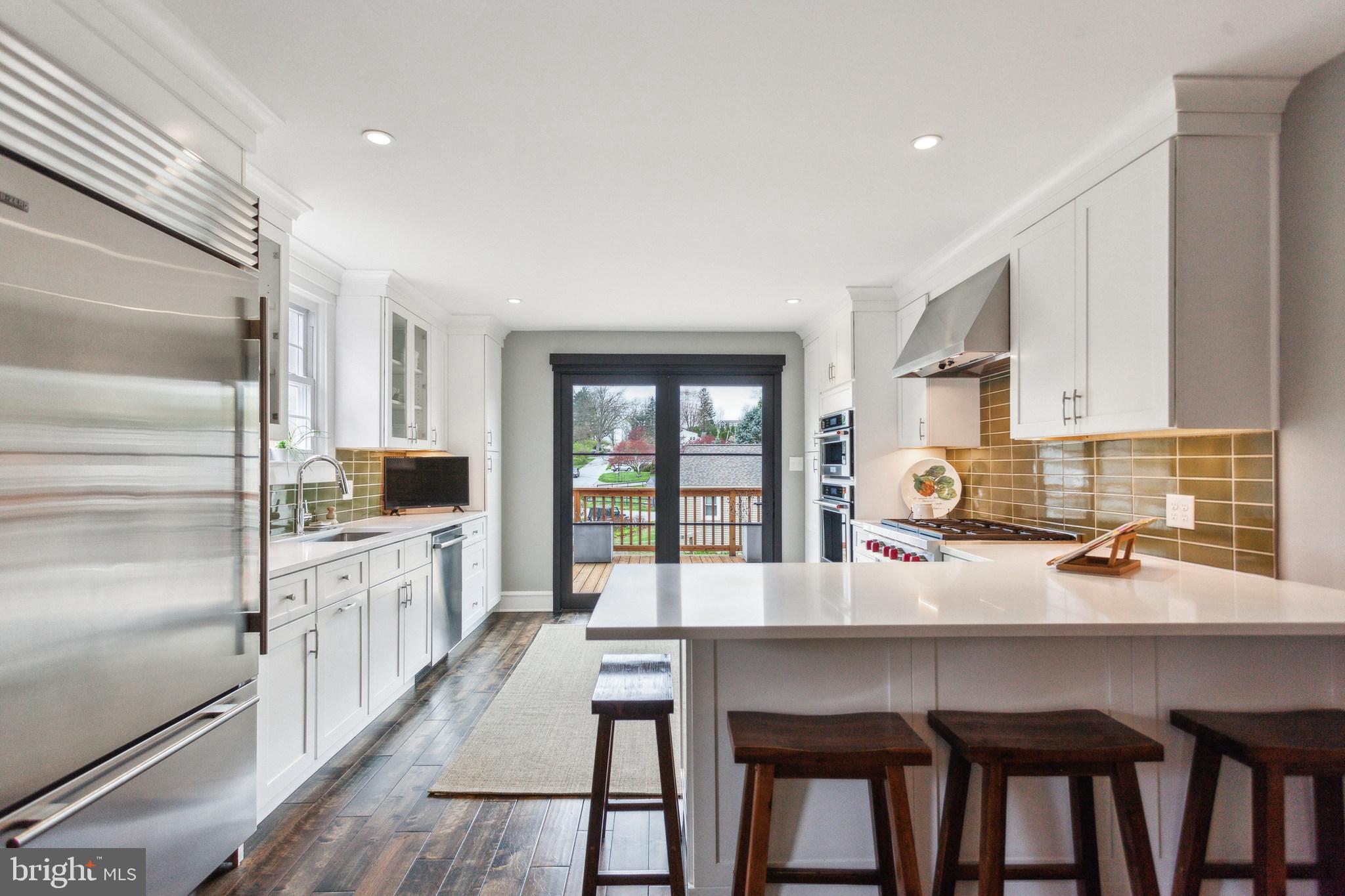 20 Moreland Road Paoli, PA 19301 - Photo 12 of 30 a kitchen with a table chairs refrigerator and cabinets