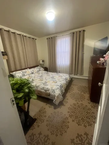 a bedroom with a bed and a mirror