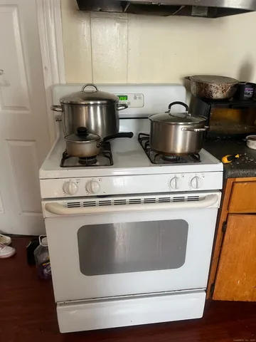 a stove top oven sitting inside of a kitchen
