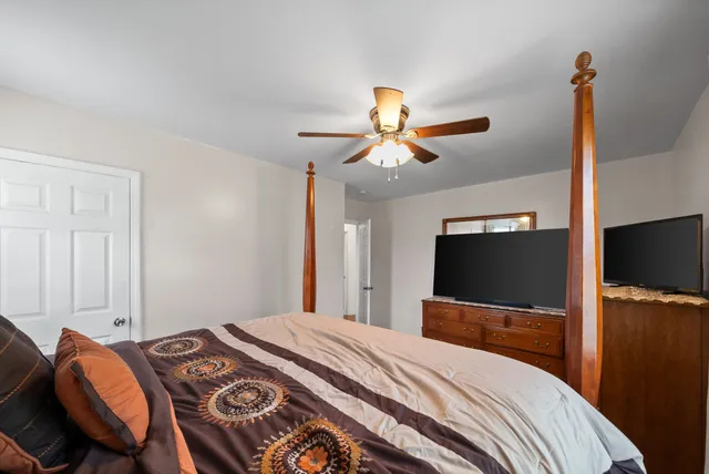 a view of a hallway with workspace and livingroom with furniture