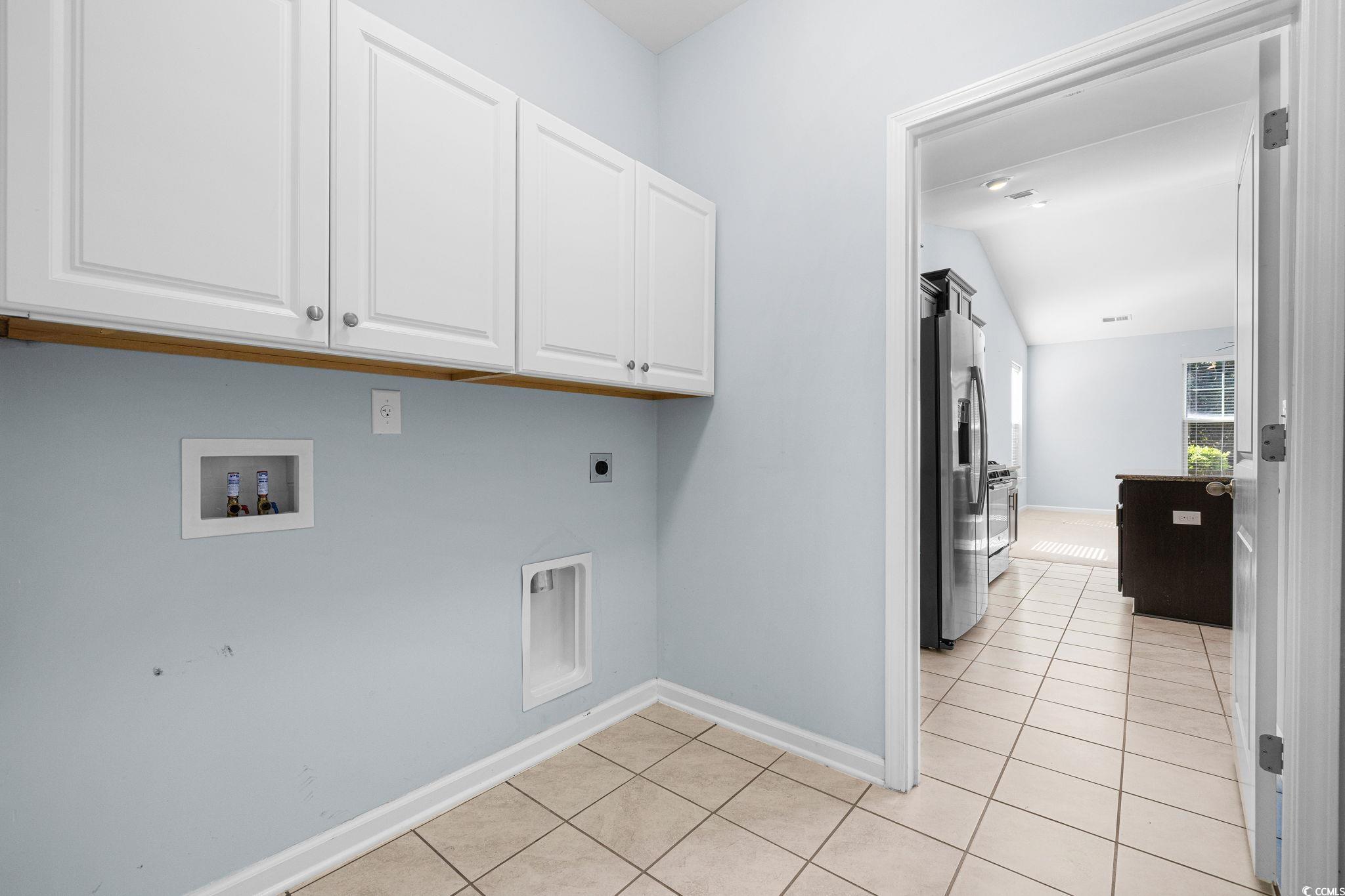 817 Arezzo Way, Unit 1001 Myrtle Beach, SC 29579 - Photo 20 of 40 Laundry room featuring light tile patterned floors, hookup for an electric dryer, cabinet space, and hookup for a washing machine