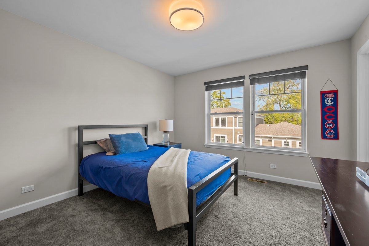 828 Chestnut Street Deerfield, IL 60015 - Photo 18 of 29 a bed sitting in a bedroom next to a window