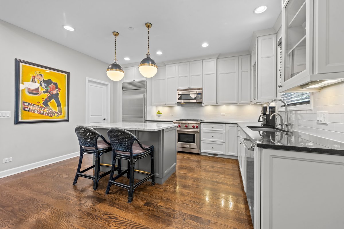 828 Chestnut Street Deerfield, IL 60015 - Photo 6 of 29 a kitchen with stainless steel appliances granite countertop a sink a stove a refrigerator cabinets and a dining table