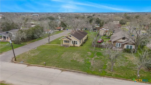 an aerial view of a house with a garden and a yard