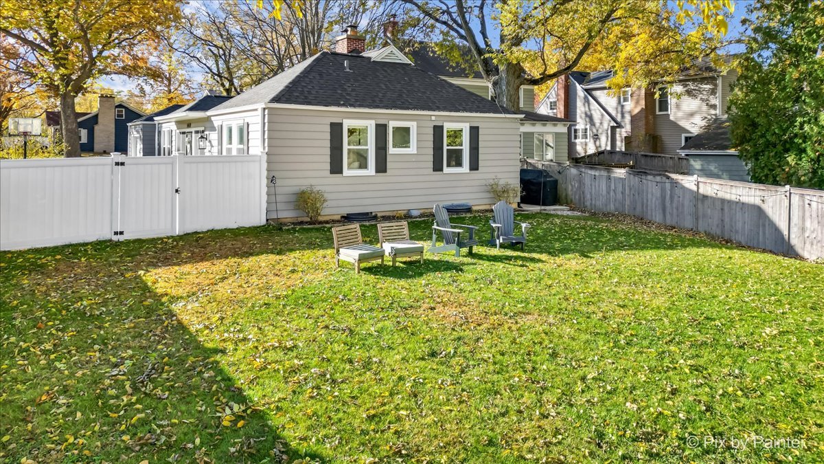 625 South Harrison Street Batavia, IL 60510 - Photo 25 of 43 a view of backyard of house with wooden fence and large trees