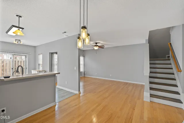 a view of a kitchen with wooden floor and staircase