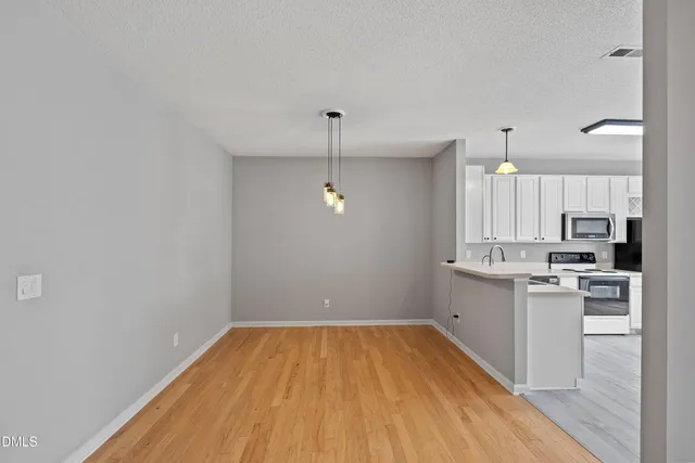 a bathroom with a sink and steel appliances