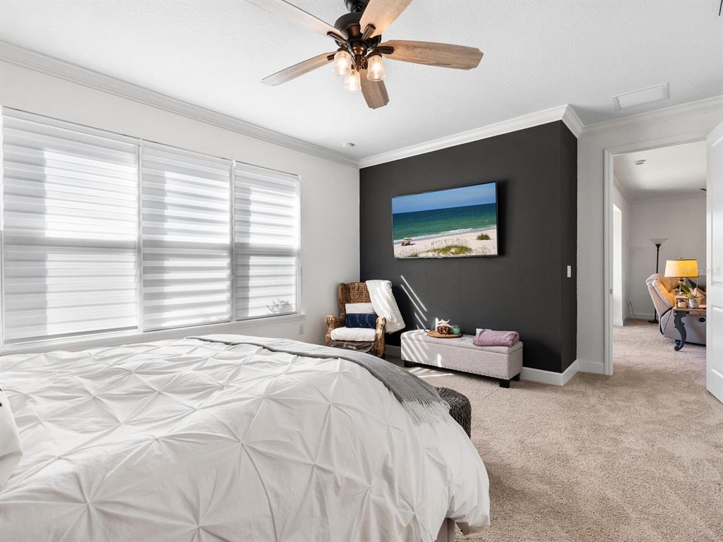 15317 Isla Palma Lane Nokomis, FL 34275 - Photo 11 of 25 a bedroom with a bed and a chandelier