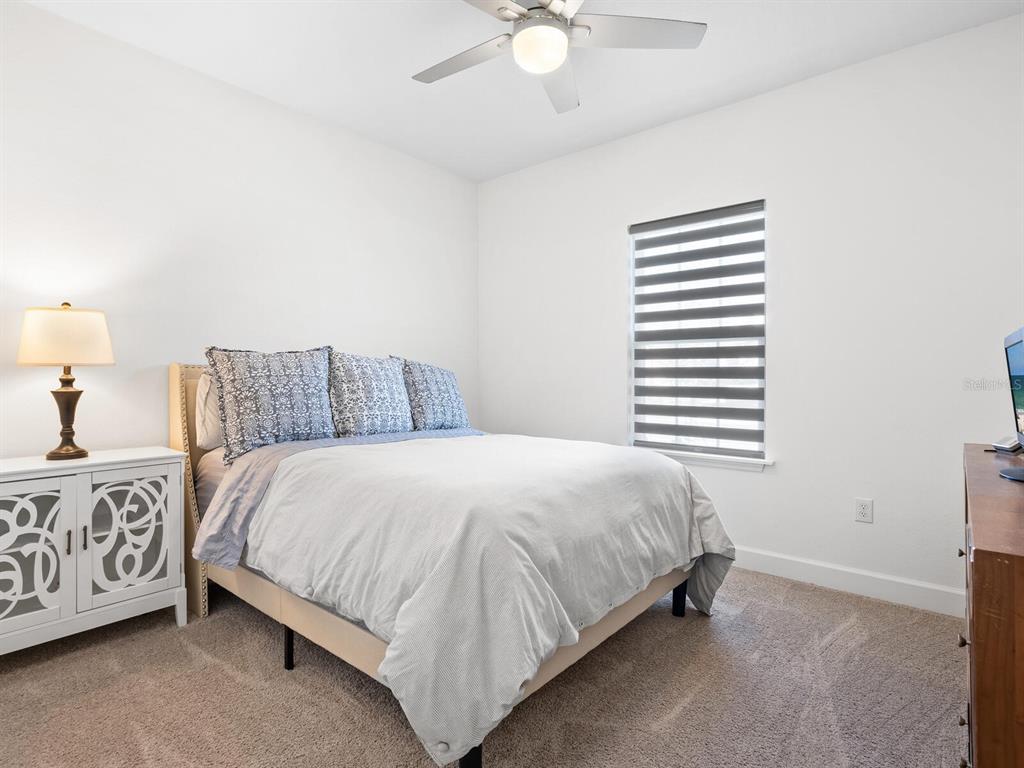 15317 Isla Palma Lane Nokomis, FL 34275 - Photo 14 of 25 a bedroom with a bed and a night stand