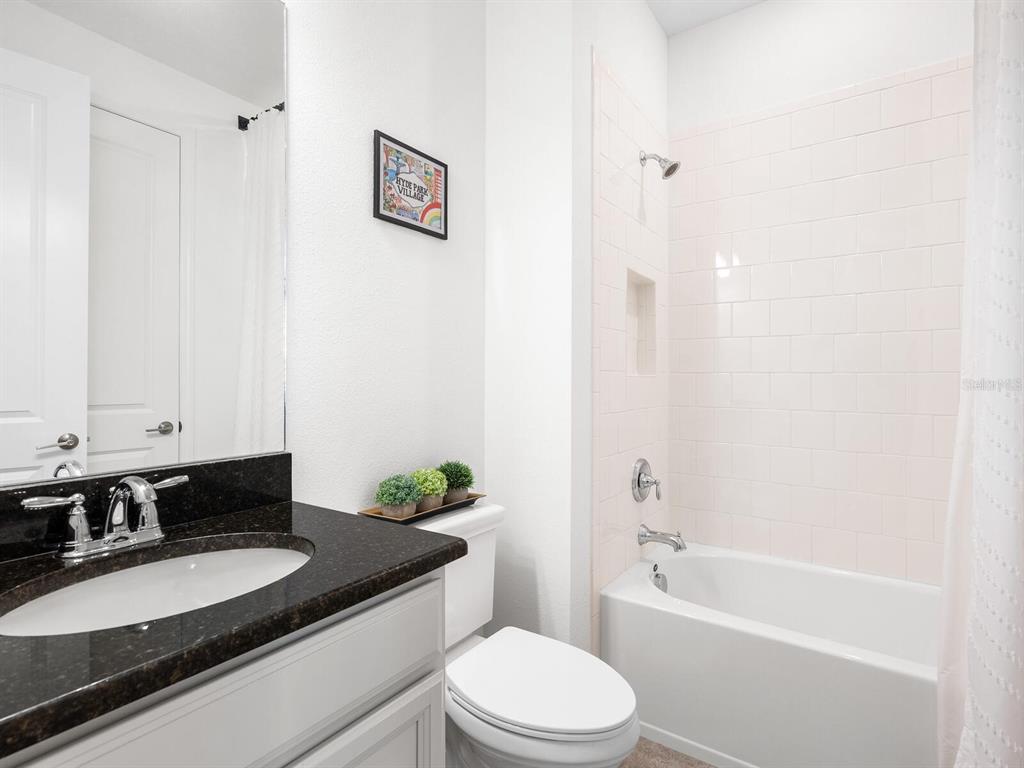 15317 Isla Palma Lane Nokomis, FL 34275 - Photo 18 of 25 a bathroom with a granite countertop sink toilet and shower