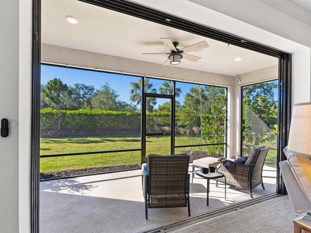 15317 Isla Palma Lane Nokomis, FL 34275 - Photo 19 of 25 a view of a porch with furniture and a yard