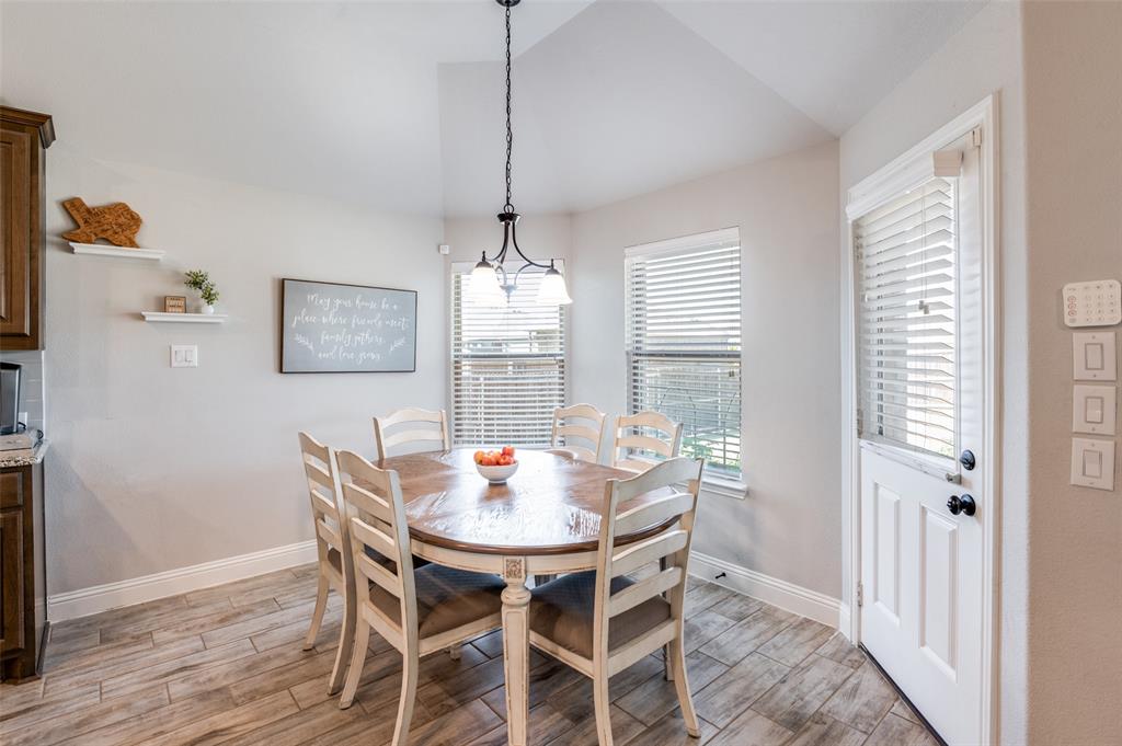 3011 Razorback Street Melissa, TX 75454 - Photo 11 of 25 a view of a dining room with furniture wooden floor and chandelier