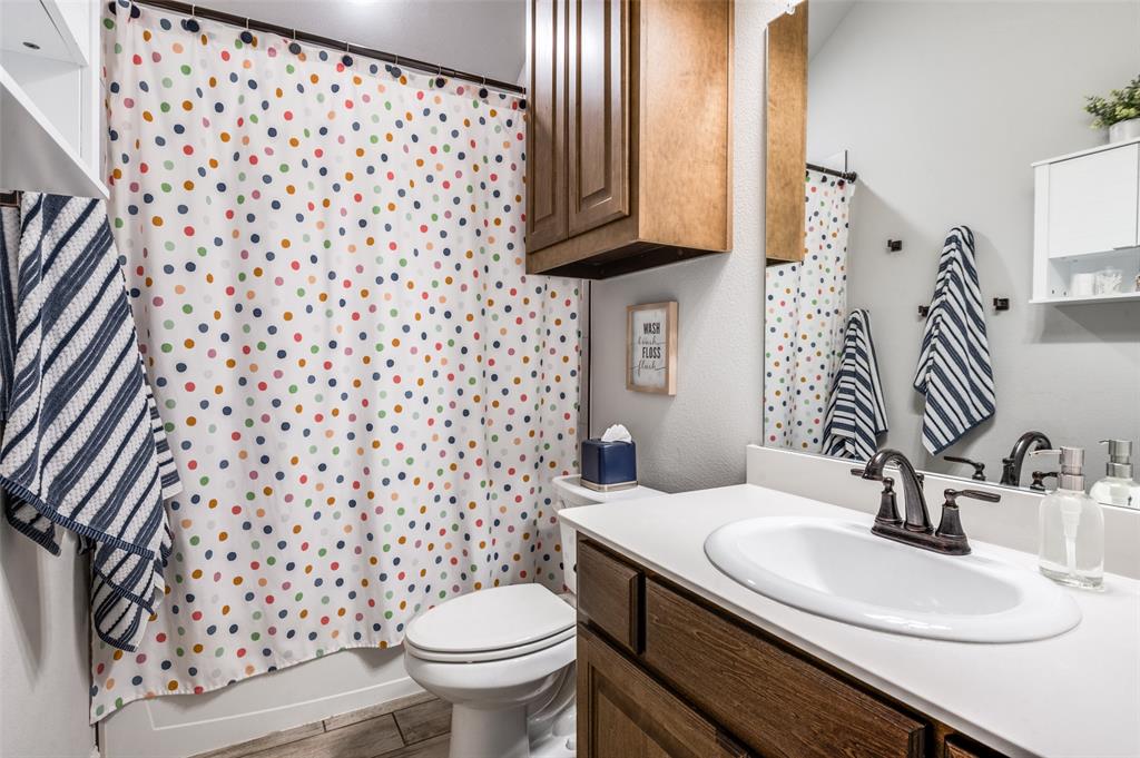 3011 Razorback Street Melissa, TX 75454 - Photo 15 of 25 a bathroom with a sink toilet and mirror