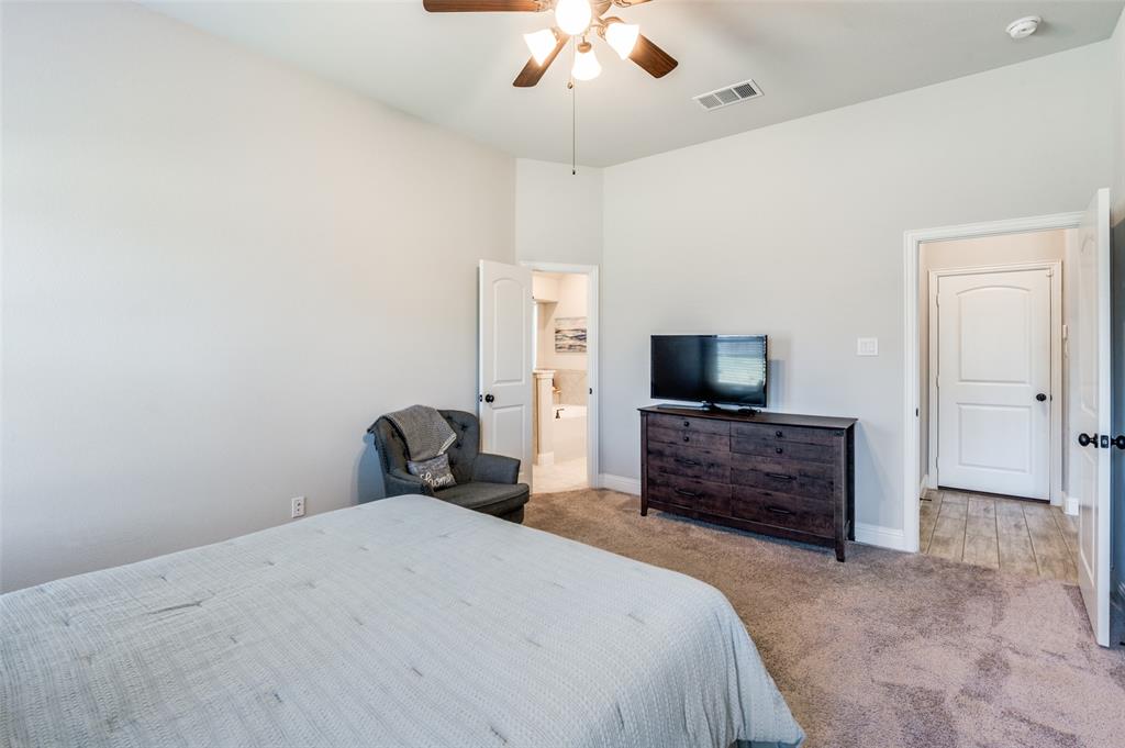 3011 Razorback Street Melissa, TX 75454 - Photo 17 of 25 a bedroom with a bed and a flat screen tv