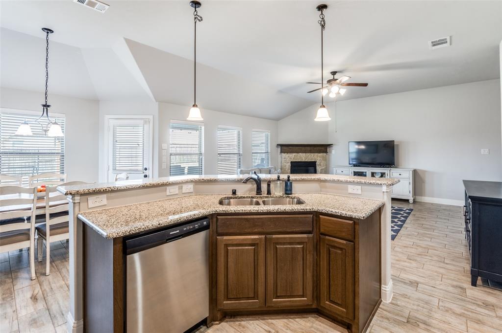 3011 Razorback Street Melissa, TX 75454 - Photo 7 of 25 a kitchen with stainless steel appliances granite countertop a sink a stove and a refrigerator