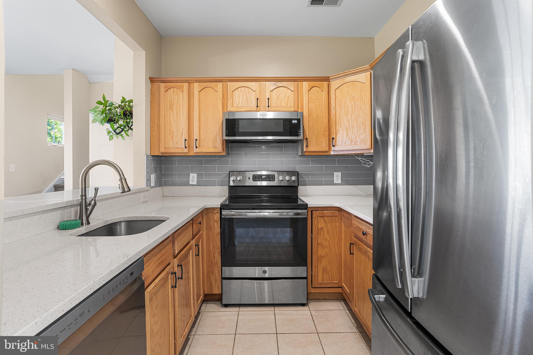 6 Wilson Way, Unit 3 Delanco, NJ 08075 - Photo 5 of 31 a kitchen with a stove a sink and a refrigerator