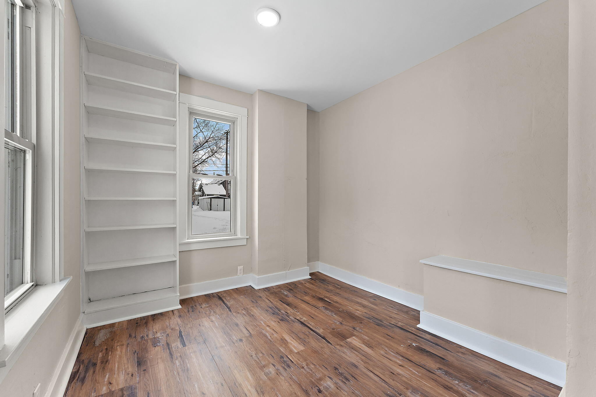 107 Franklin Street Porter, IN 46304 - Photo 6 of 22 a view of an empty room with a window and wooden floor