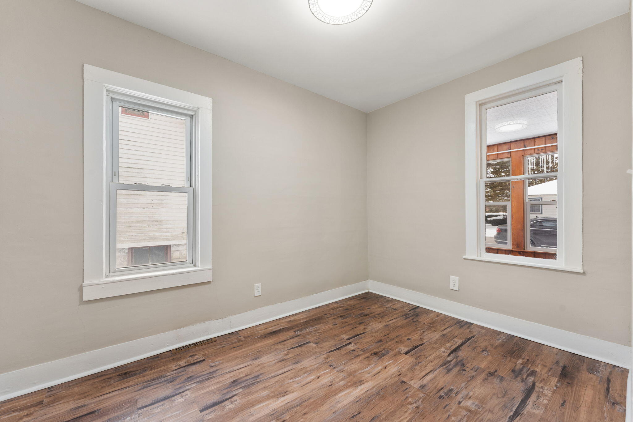 107 Franklin Street Porter, IN 46304 - Photo 7 of 22 an empty room with a window and wooden floor