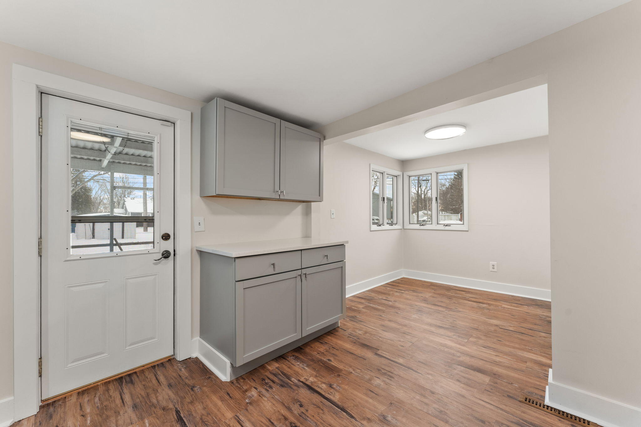 107 Franklin Street Porter, IN 46304 - Photo 8 of 22 a kitchen with white cabinets and wooden floor