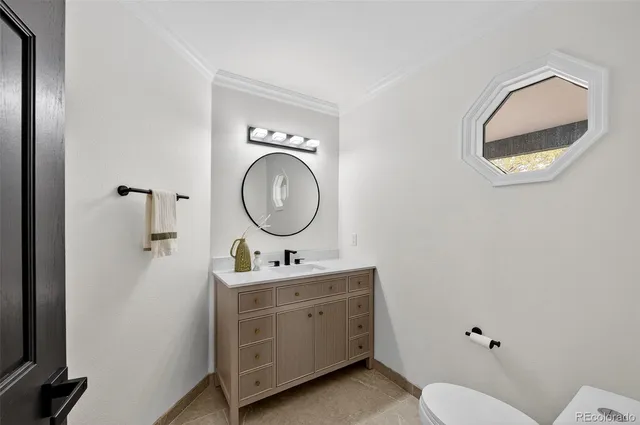 a living room with furniture a fireplace and a chandelier