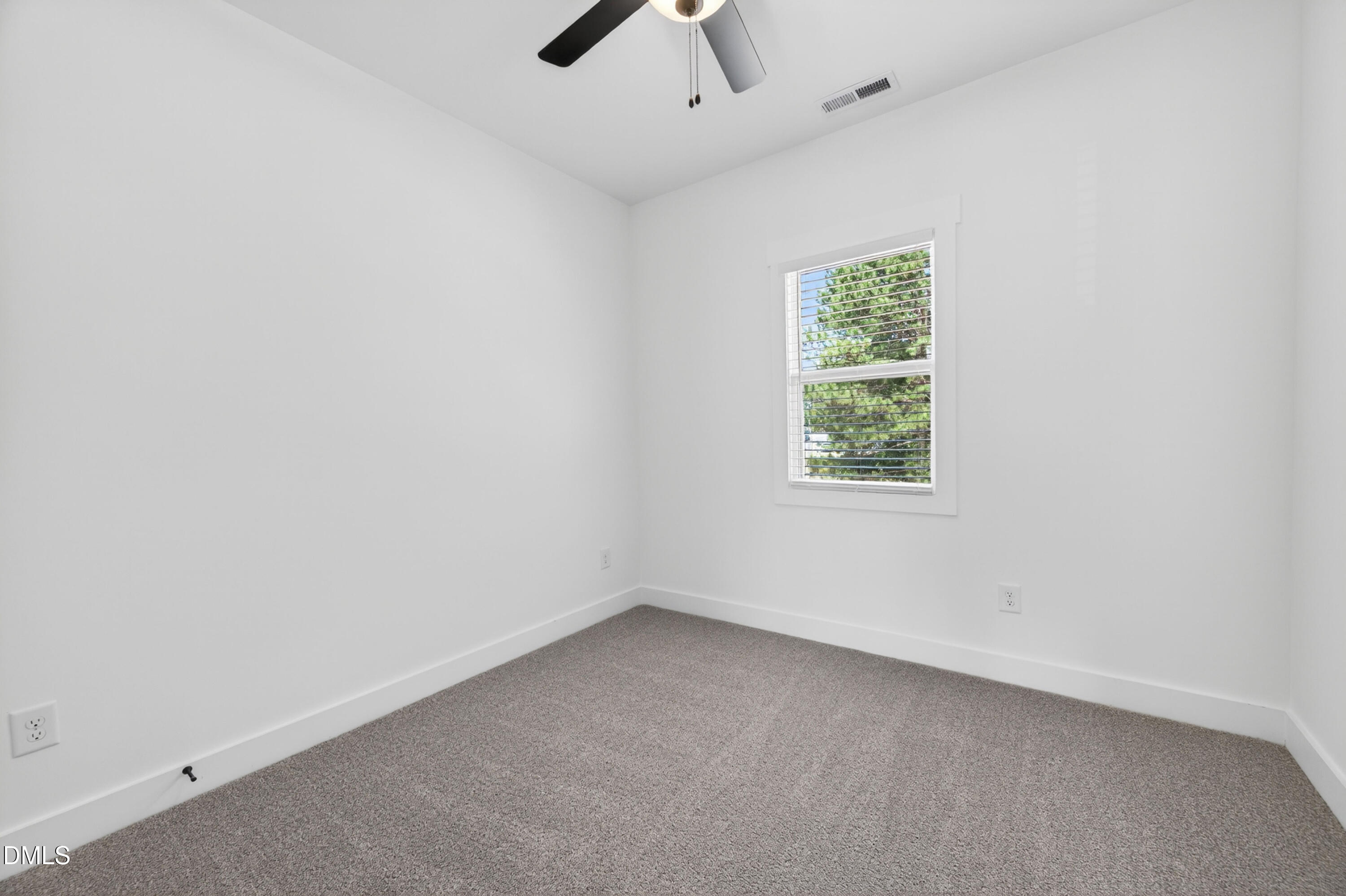 1196 Hurdle Mills Road Roxboro, NC 27573 - Photo 26 of 50 an empty room with a window and a fan