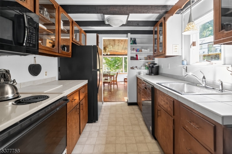 46 Glenside Trail Sparta, NJ 07871 - Photo 14 of 31 a kitchen with stainless steel appliances a sink stove and cabinets