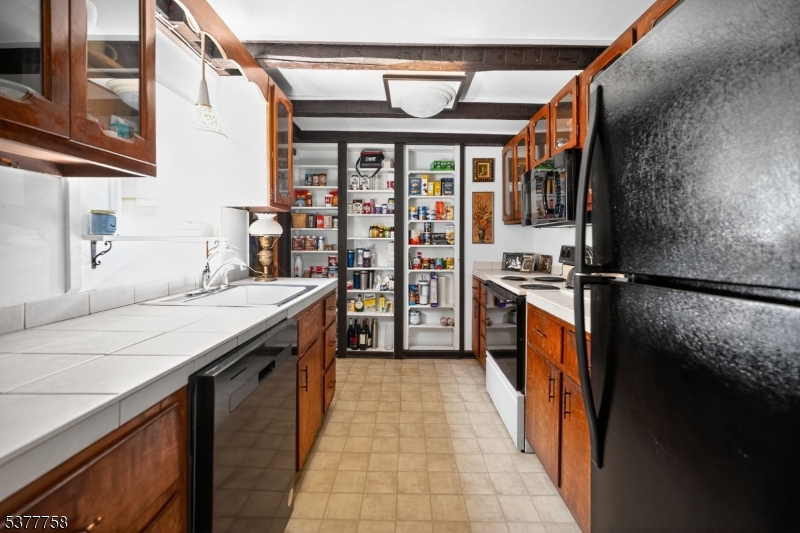 46 Glenside Trail Sparta, NJ 07871 - Photo 15 of 31 a kitchen with stainless steel appliances granite countertop a sink and a refrigerator