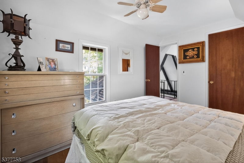 46 Glenside Trail Sparta, NJ 07871 - Photo 21 of 31 a bedroom with a bed and a chandelier