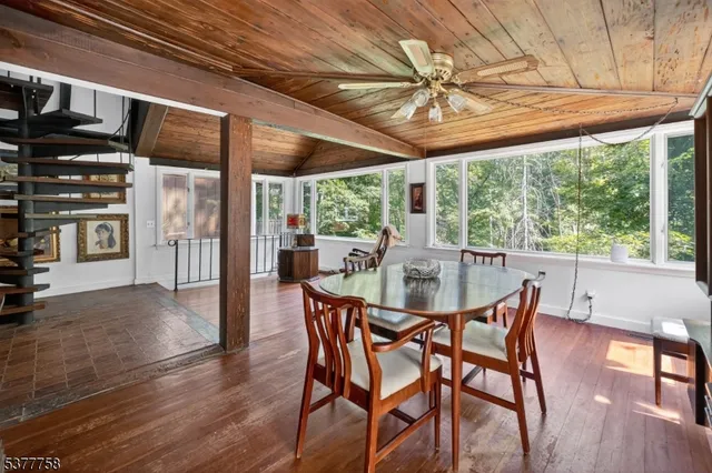a dining room with furniture window and wooden floor