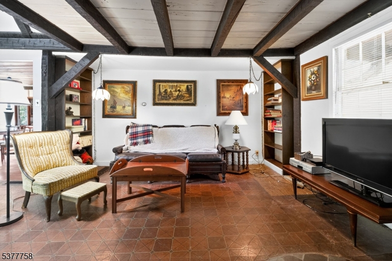 46 Glenside Trail Sparta, NJ 07871 - Photo 10 of 31 a living room with furniture and a flat screen tv with kitchen view