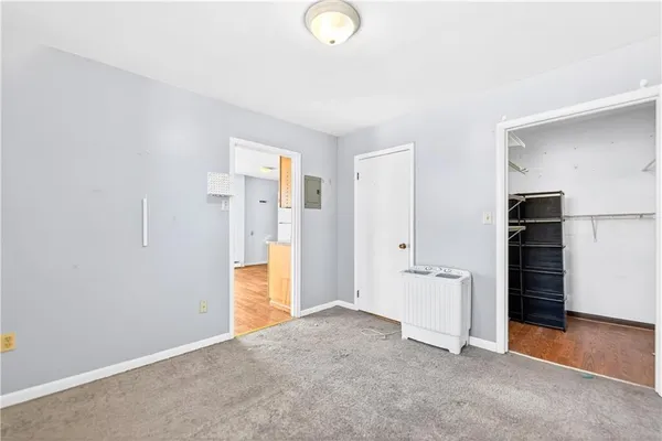 a view of walk in closet with empty racks