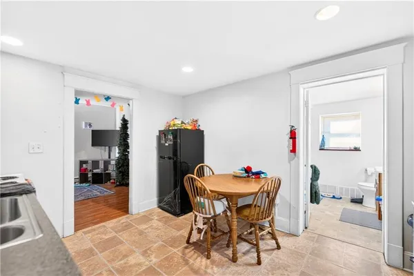 a kitchen with stainless steel appliances kitchen island granite countertop a refrigerator and a sink