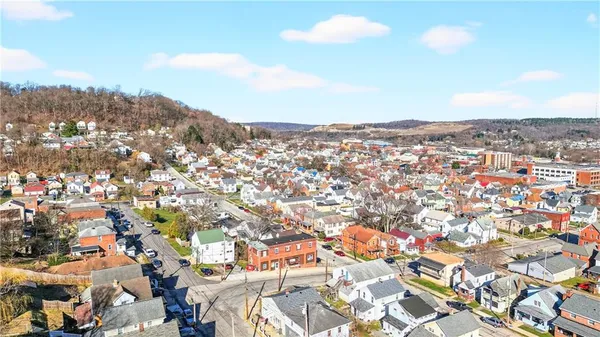 an aerial view of a houses with a swimming pool