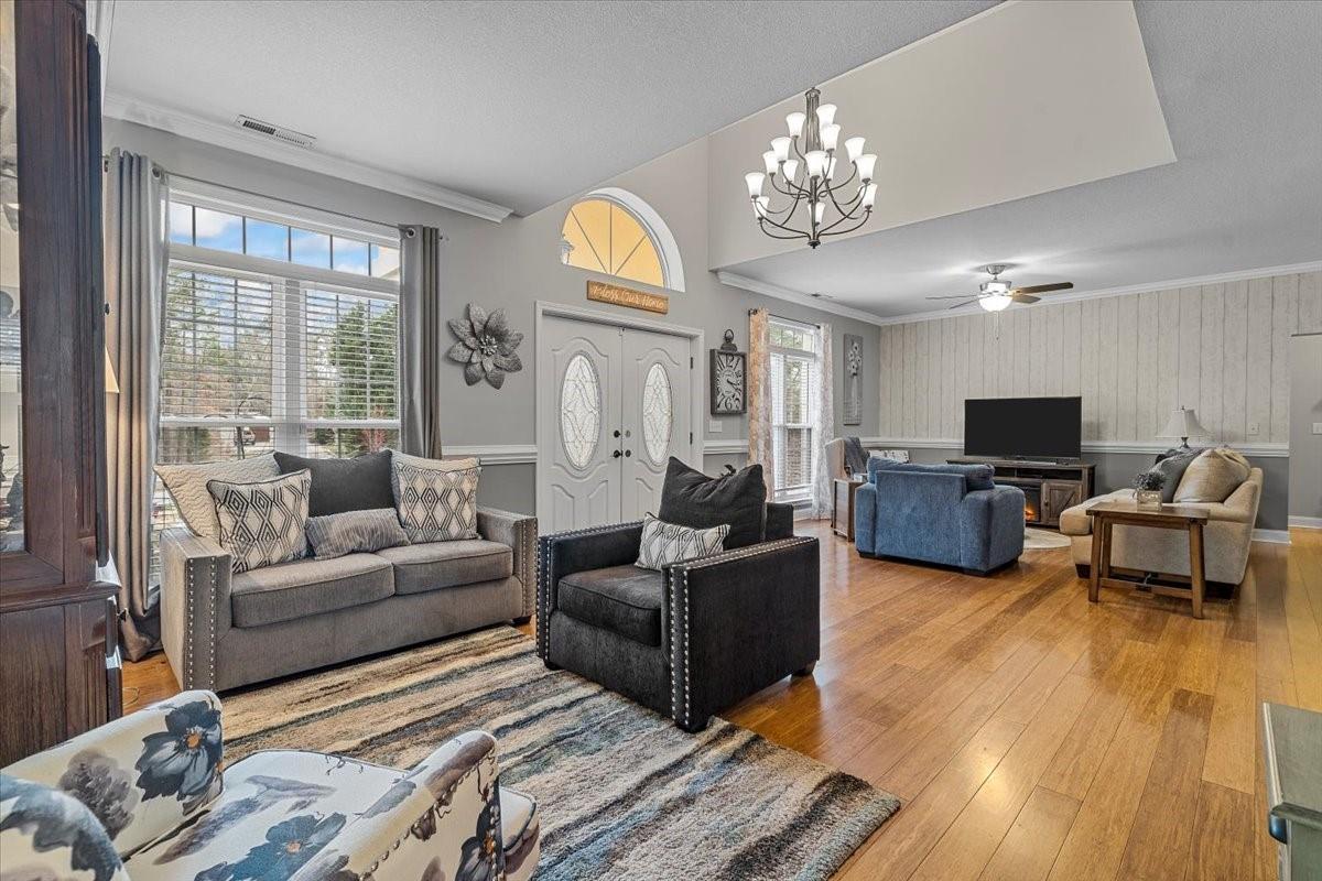 326 Point Carpenter Road Indian Land, SC 29707 - Photo 22 of 48 a living room with furniture a large window and a chandelier