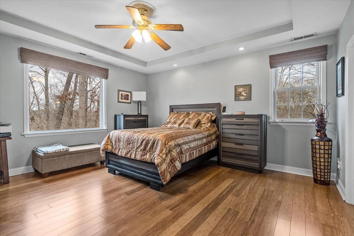 326 Point Carpenter Road Indian Land, SC 29707 - Photo 24 of 48 a bedroom with a large bed and a chandelier