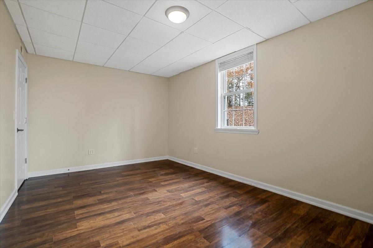 326 Point Carpenter Road Indian Land, SC 29707 - Photo 34 of 48 an empty room with wooden floor and windows