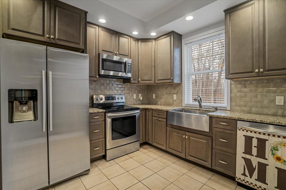 326 Point Carpenter Road Indian Land, SC 29707 - Photo 35 of 48 a kitchen with stainless steel appliances granite countertop a stove a sink and a microwave