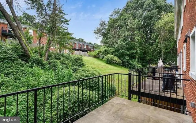 a view of a balcony with a small yard