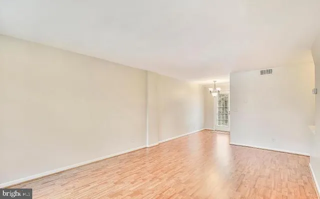 a view of an empty room and wooden floor