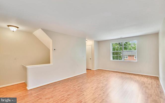 4615 B 28th Road South, Unit B Arlington, VA 22206 - Photo 7 of 24 a view of an empty room with wooden floor and a window