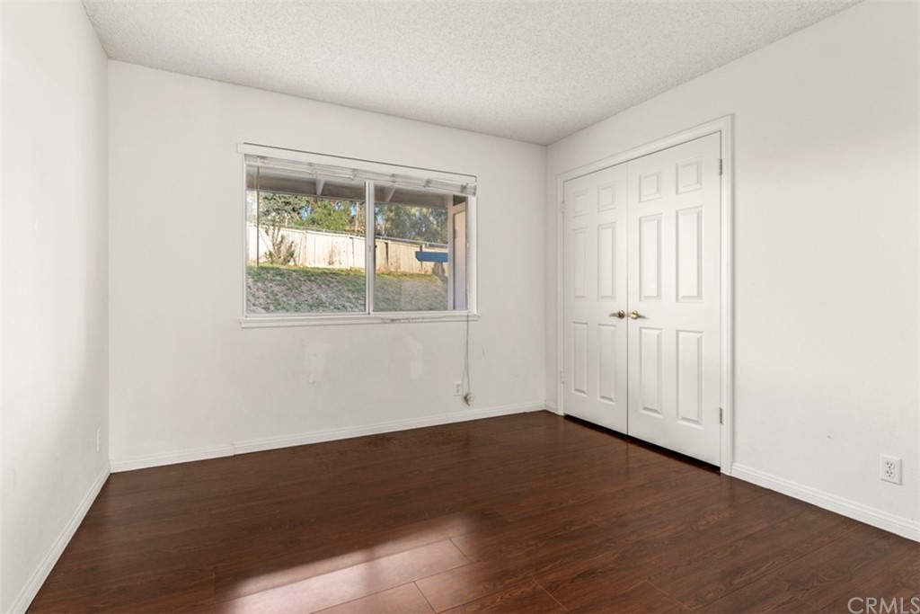 1856 Gird Road Fallbrook, CA 92028 - Photo 12 of 39 an empty room with wooden floor and windows
