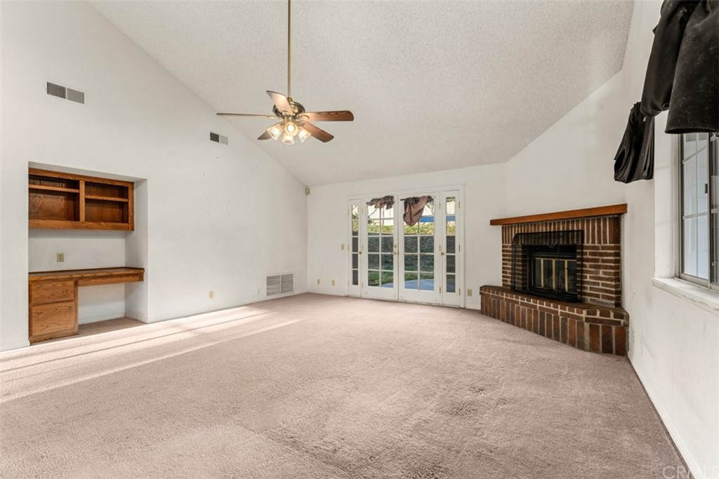 1856 Gird Road Fallbrook, CA 92028 - Photo 19 of 39 a view of an empty room with a fireplace and a window