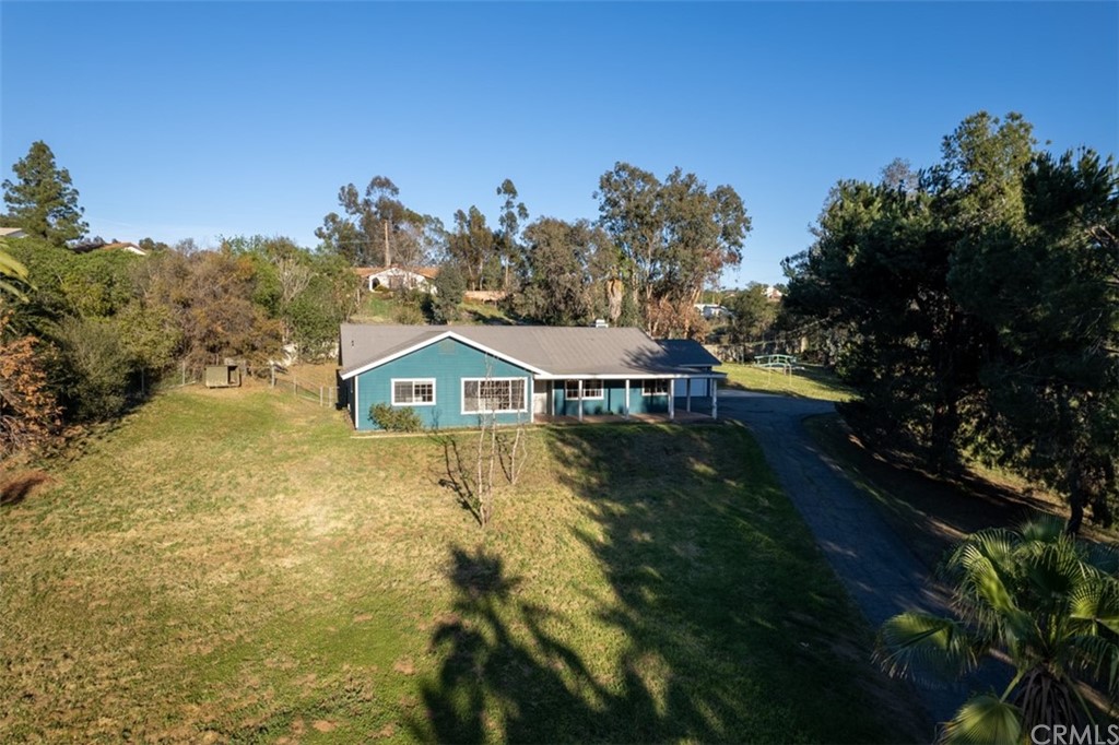 1856 Gird Road Fallbrook, CA 92028 - Photo 29 of 39 a view of a big house with a big yard and large tree